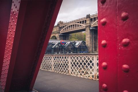aspire office viewed through a red bridge