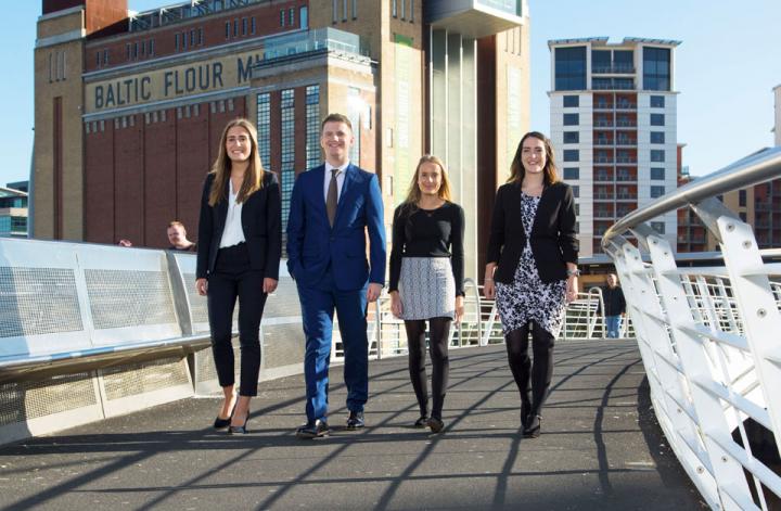 Apprentices walking across bridge