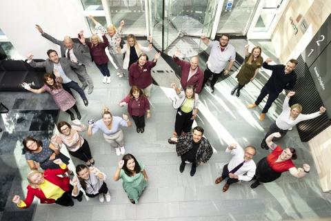 Staff from Muckle and charities forming the number 20 with their bodies