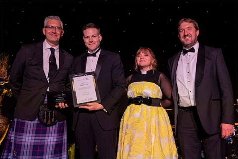 Adam Rayner, partner at Muckle LLP, receiving the award