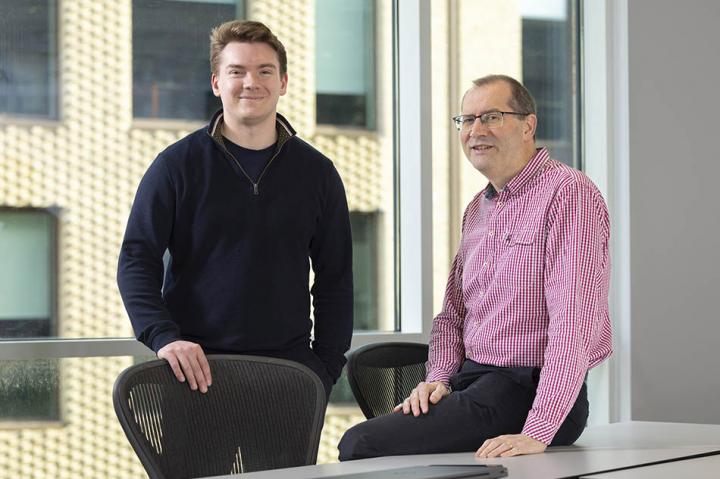 Craig Harvey, standing, and Chris Maddock, sitting, looking at the camera