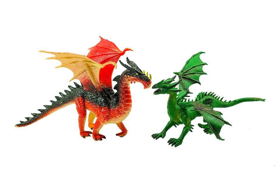 Two toy dragons, one red and black and the other green, on a white background