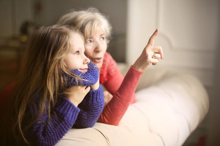 grandparent with grandchild pointing