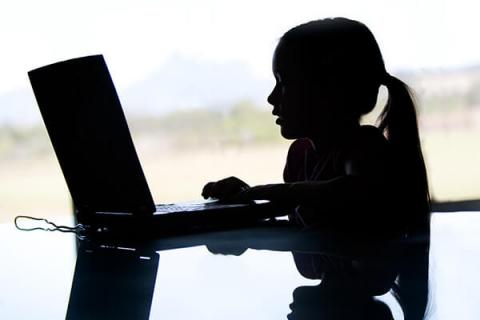 silhouette of girl on laptop