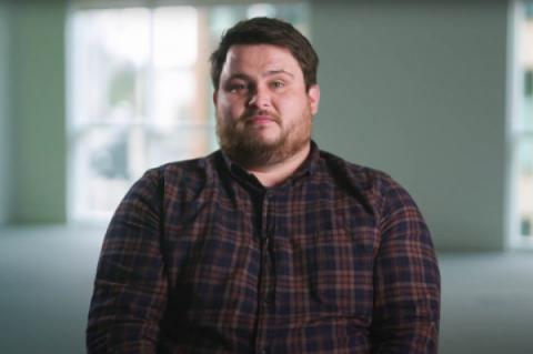 Matt Brady sitting in a chair and looking at the camera