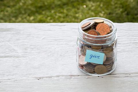 Jar full of pennies with the word give written on it