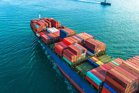 a shipping container with colourful containers at sea