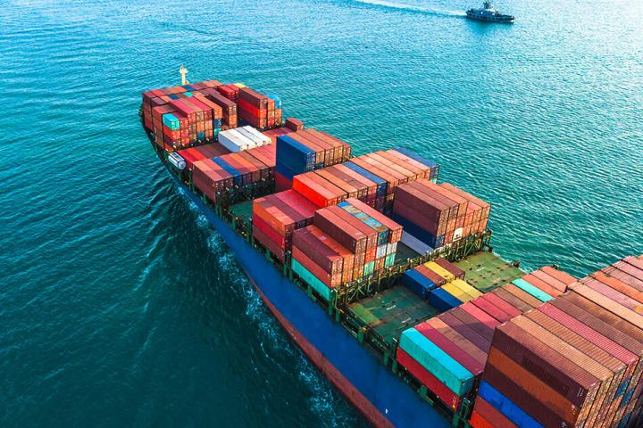 a shipping container with colourful containers at sea