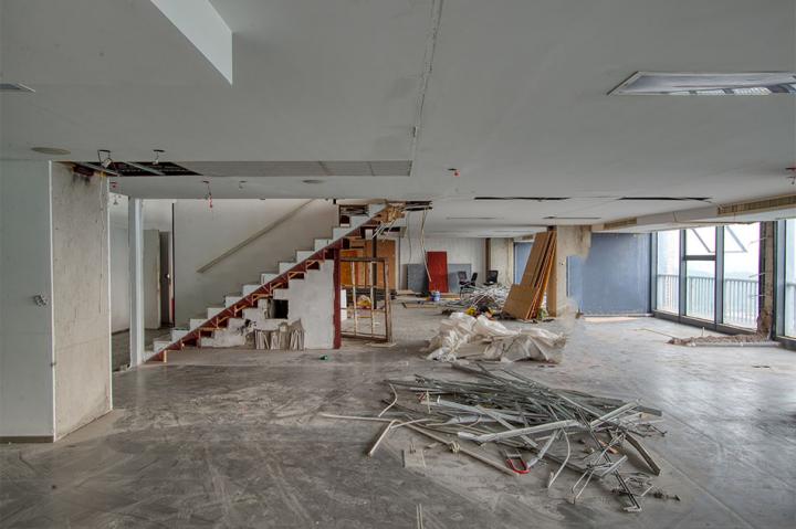 A commercial office space with with rubbish and rubble in the foreground