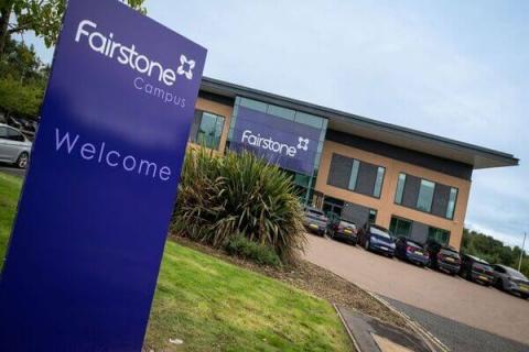 Picture of Fairstone new building in the background with a fairstone welcome sign in the foreground