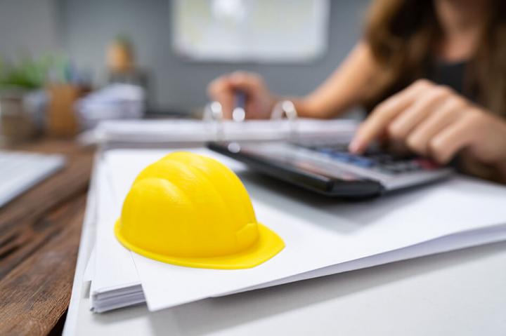 construction hat next to a calculator