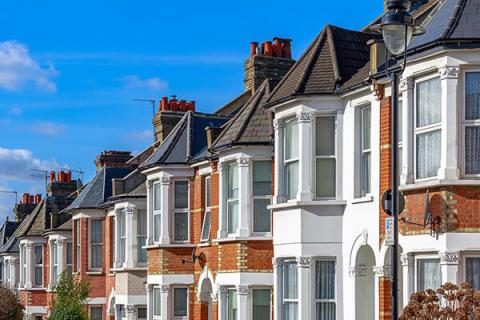 a row of red and white terraced houses on a street