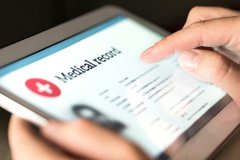 Close up of a tablet device displaying a medical record example