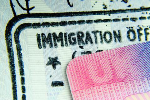 Close up of a UK passport stamp stating Immigration Office