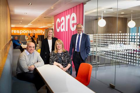 Jason wainwright, Nicola Leyden, Debbie McCormick and Hugh Welch sitting at a table in the Muckle office. The words 'responsibility' and care are on the walls in the background