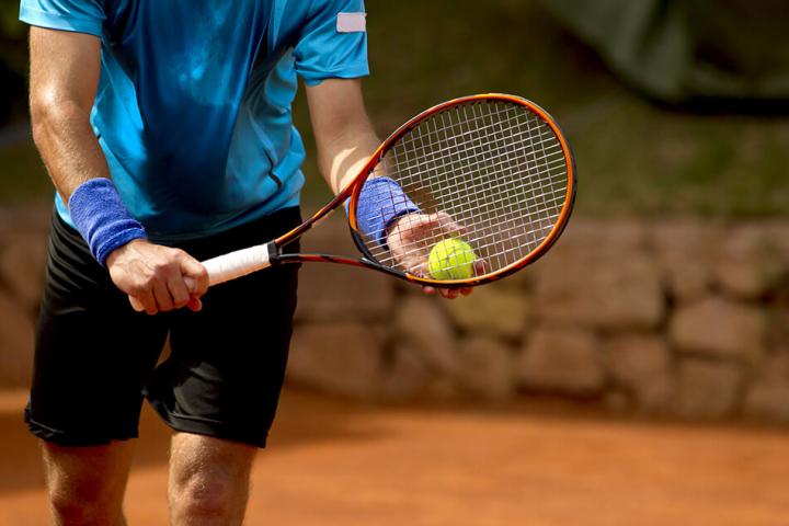 Man serving a tennis ball