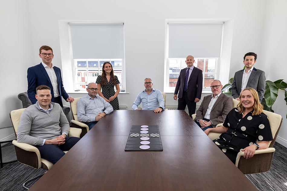 Advisers from Muckle LLP, WilliamsAli, and UNW sitting around a table with Mitten Mitten, CEO of Houghton, in the centre