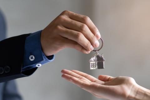 Renter receiving keys to their new house from landlord
