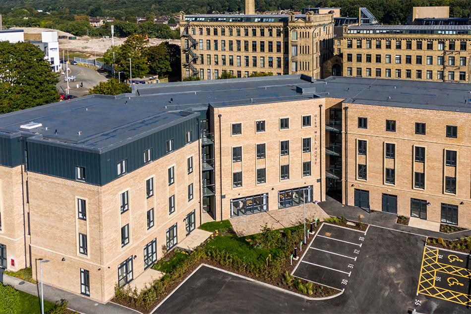 Bird's eye view of Torsion Care’s Shipley Manor facility, a set of three beige buildings with a car park in front