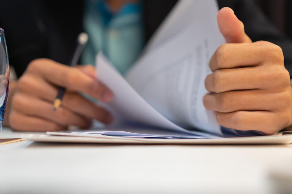 Man in a legal meeting managing paperwork