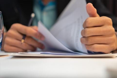 Man finalising paperwork in a legal meeting