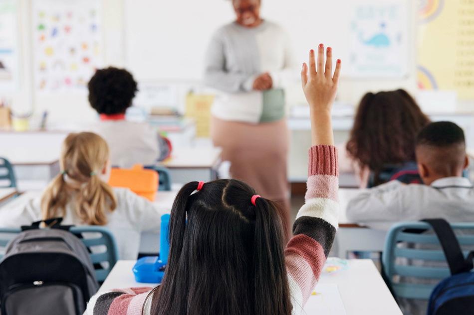 Students asking teacher for assistant in classroom