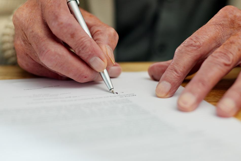 Man writing will in legal office