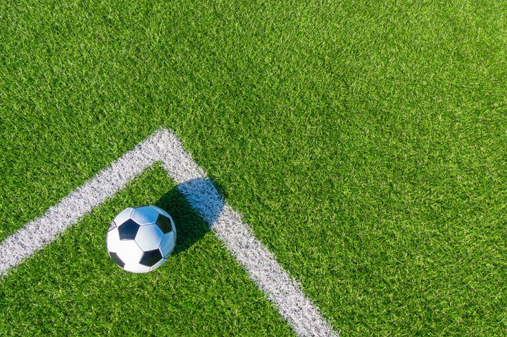 Image of a football on a football pitch