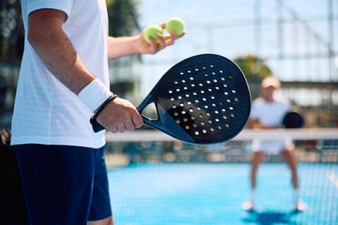 Two people beginning a padel match