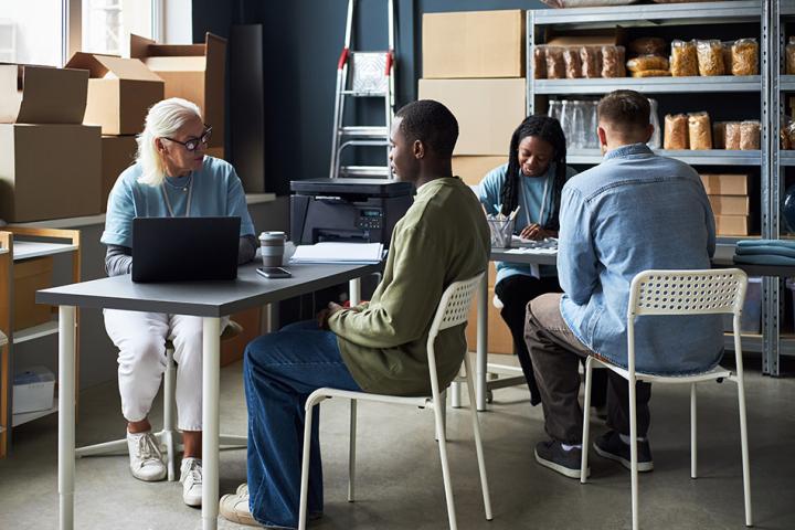 Employees of a charity engaging in a meeting