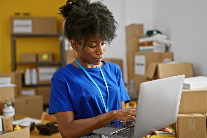 Charity employee completing administrative work on a laptop