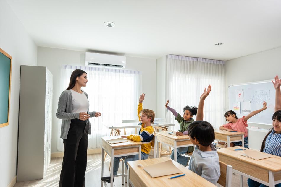 A teacher teaching a classroom of primary school students