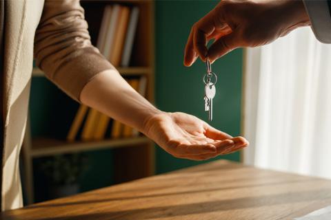 Landlord handing over keys to a new rental property