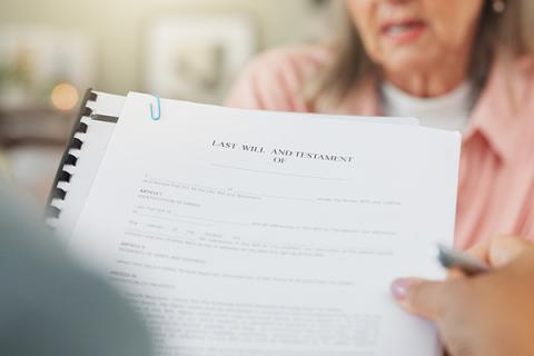 Image of a last will and testament being read to a woman