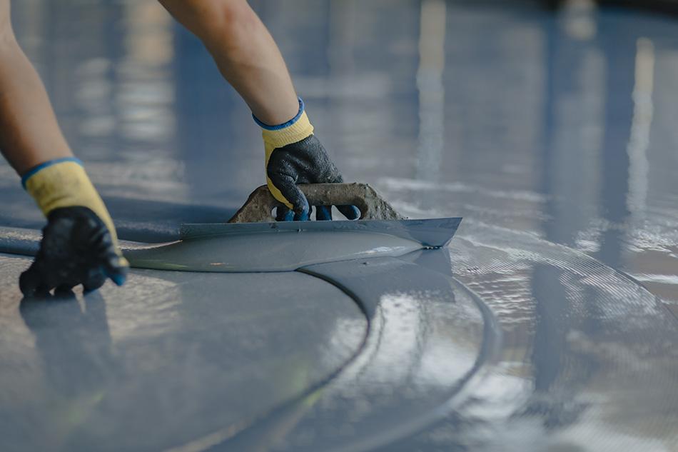 A construction worker laying resin surfacing