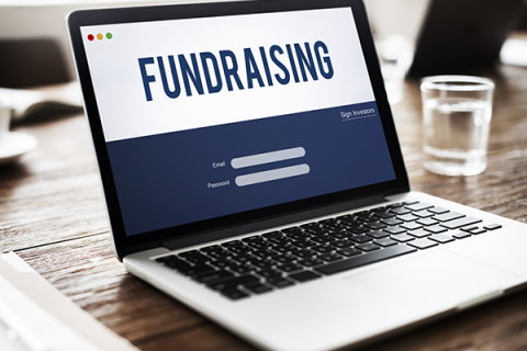 Someone browsing a fundraising webpage on a laptop screen