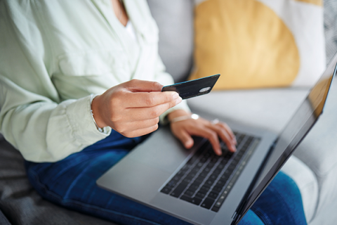 A woman completing an online shopping order using her laptop
