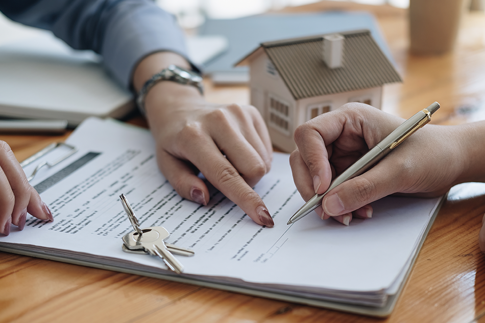 An image of a tenant signing a lease with a landlord