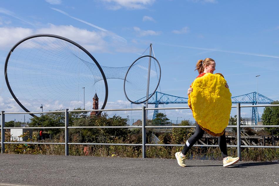 An image of Business Development Manager at Muckle LLP, Jill Cull in a chicken parmo costume training for the Great North Run