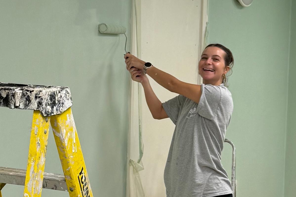 Katharine ronn painting a wall 