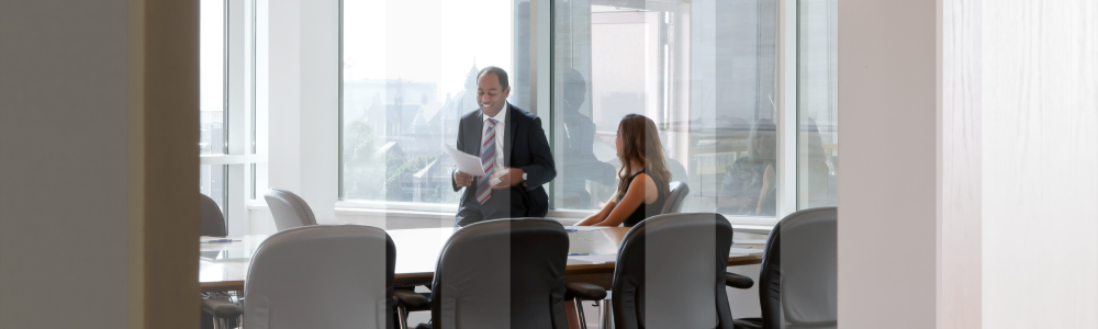 Kevin and Jess in boardroom