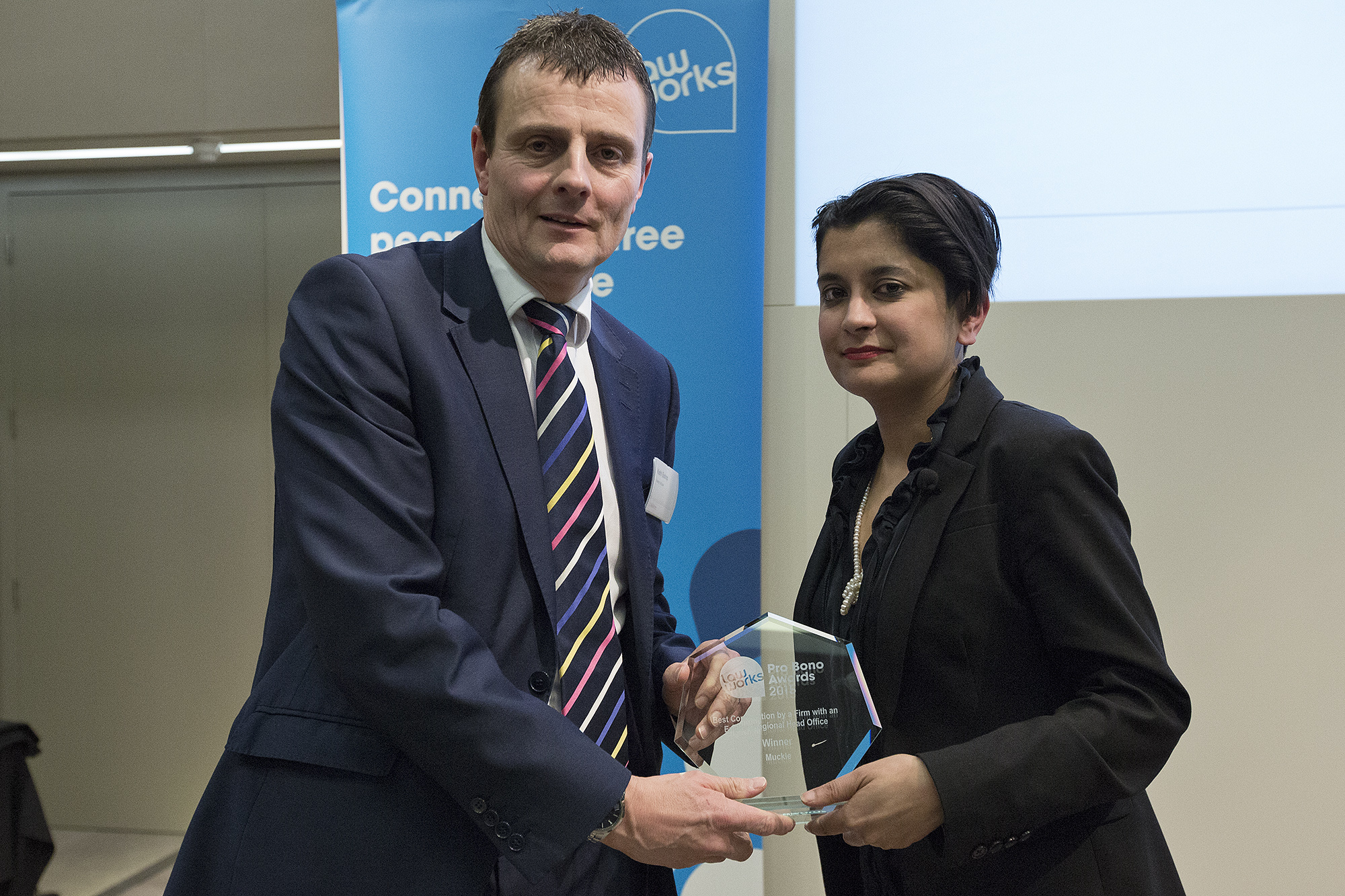 Keith Bishop receiving the Best Contribution by a Regional Law Firm on behalf of Muckle given by Shami Chakrabarti.