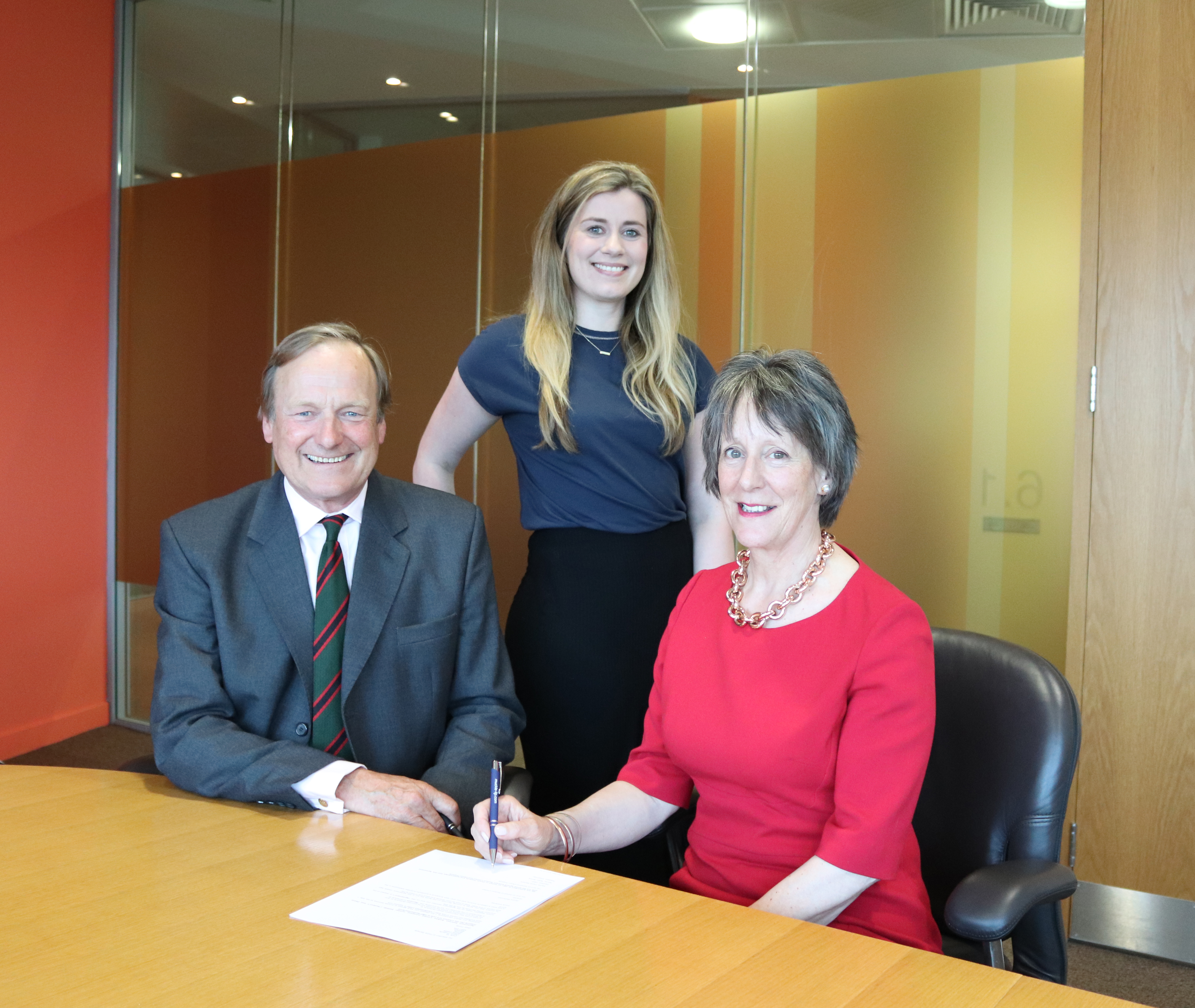 Fiona Sample and Robin Brims (Oswin) sign agreement for new prison cafe, with Sam Roberts (standing)