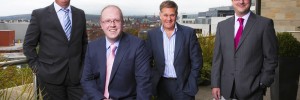 Russell Hall (sitting) with colleagues from the Real Estate team